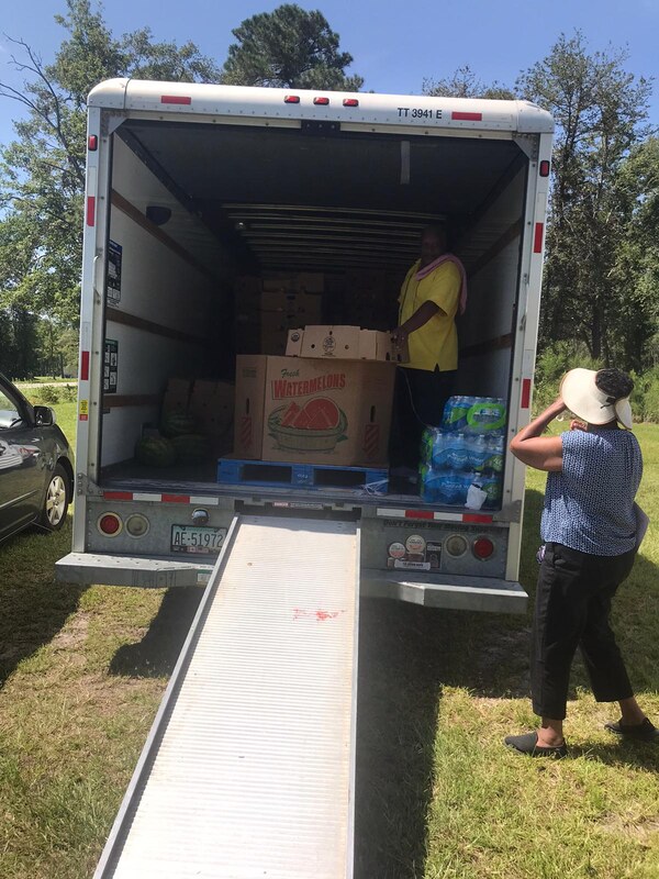 UCAN team member unloading food boxes for community delivery